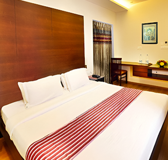 Spacious serviced apartment rooms near RS Puram Coimbatore with AC, Wi-Fi, smart TV and comfortable beds